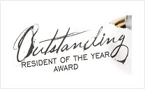 White background with the text "Outstanding Resident of the Year Award" written in black ink, accompanied by a pen