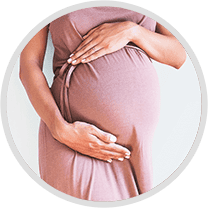 Pregnant woman with her hands on her belly, indicating that she is in the process of having a baby